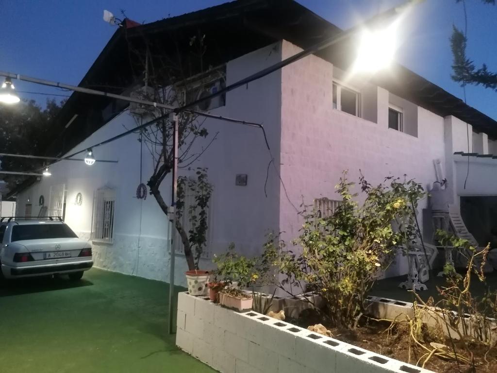 a house with a car parked in front of it at Habitaciones Don Pancho in Sax