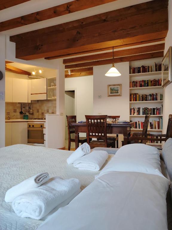 a bedroom with two beds and a kitchen with a table at 1Dest - City Center Charme in Riva del Garda