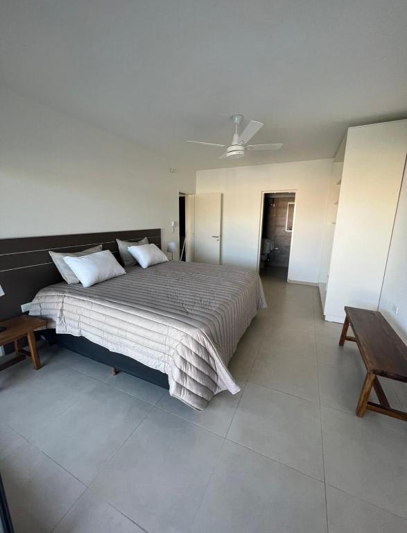 a bedroom with a large bed with a ceiling at Casaabril in Villa Carlos Paz