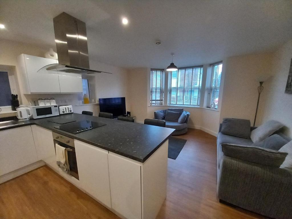 a kitchen and living room with a counter top at Modern large 2 Bed whole apartment - Free parking - Ground floor - Central Beeston in Nottingham