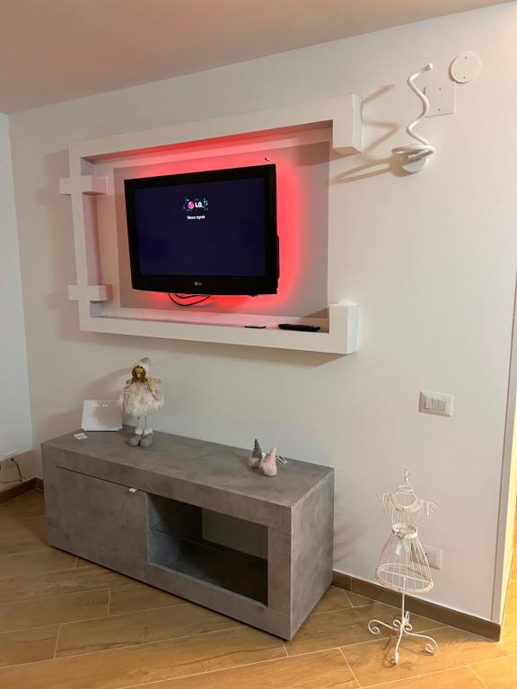 B&B Queen's Luck في إيركولانو: تلفزيون بشاشة مسطحة على جدار في غرفة المعيشة
