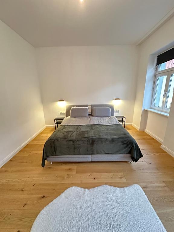 a bedroom with a large bed in a white room at Palais Living Suite in Vienna