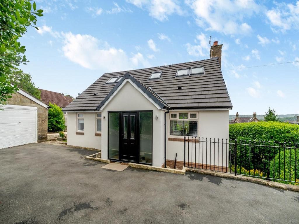 a white house with a black roof at Ryseholme in Summer Bridge