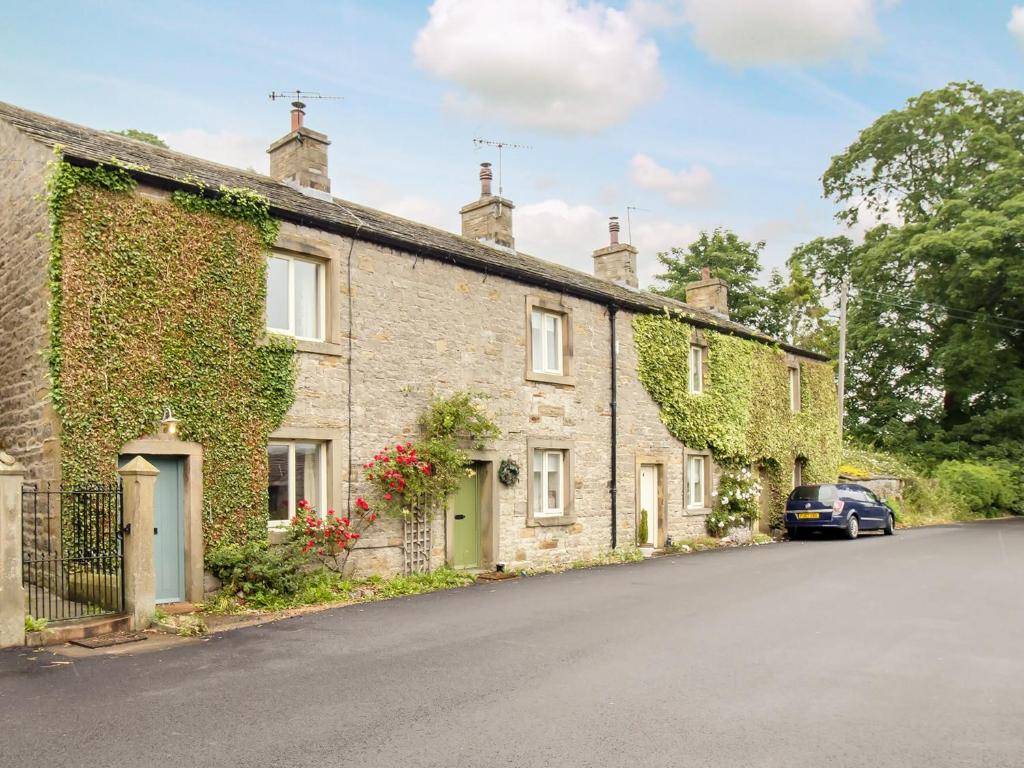a row of stone houses on a street at Ivy Cottage - Uk42246 in Broughton
