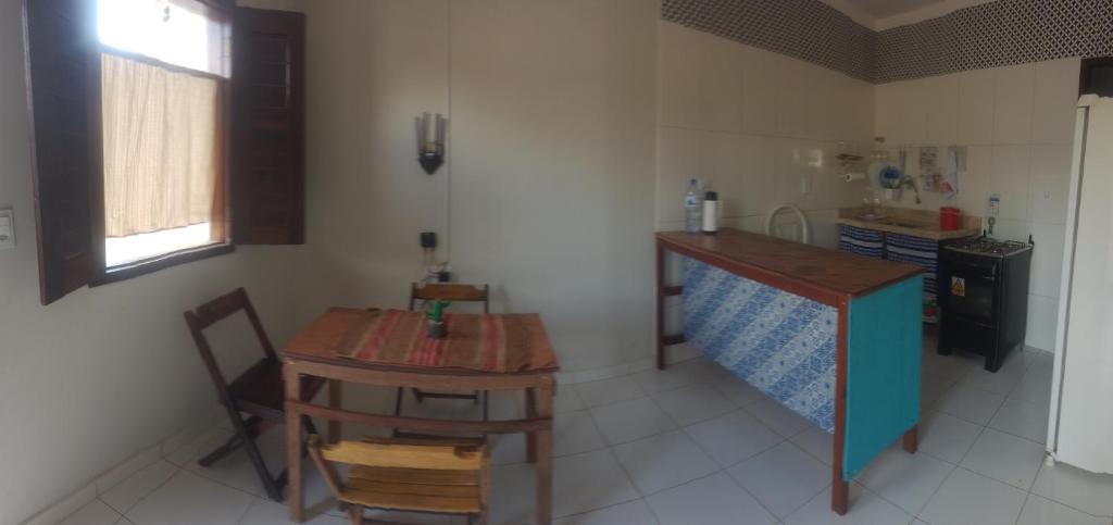 a kitchen with a table and a small table and chairs at A casinha do sonho in Lençóis