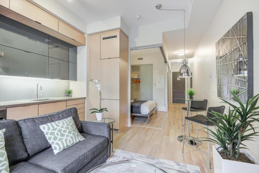 a living room with a couch and a kitchen at Luxury 2 Bedroom Downtown in Toronto