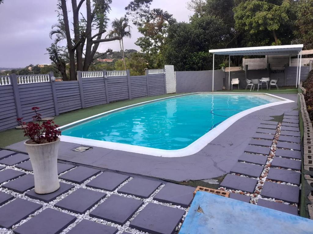 a swimming pool in a backyard with a fence at 54 Malcolm Hidden Gem near Musgrave in Durban