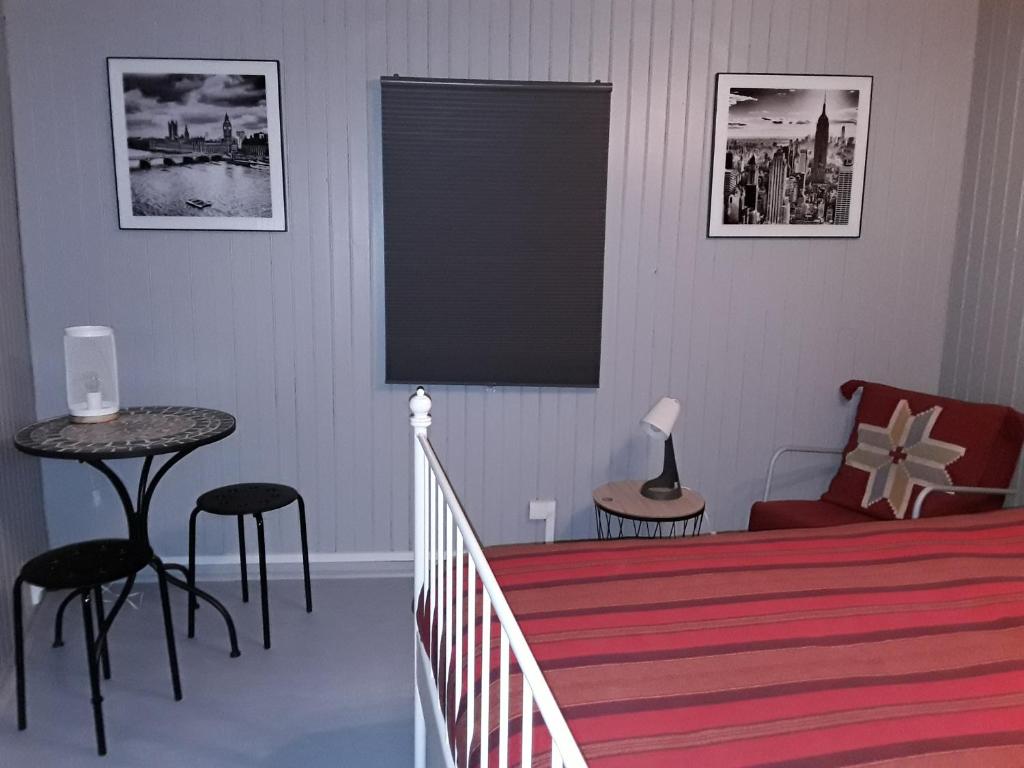 a bedroom with a bed and a table and chairs at L&#39;Armandière, maison de caractère où règne calme et sérénité. in Pézenes-les-Mines