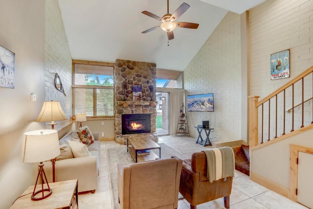 a living room with a stone fireplace at Park Avenue by All Seasons Resort Lodging in Park City