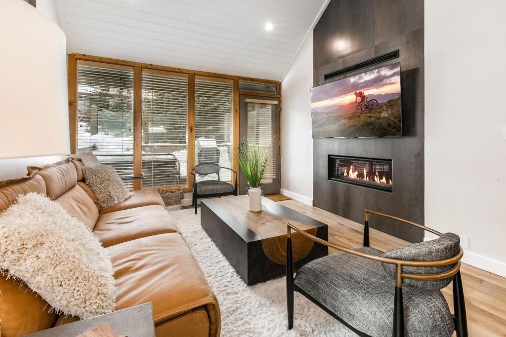a living room with a couch and a fireplace at Payday by All Seasons Resort Lodging in Park City