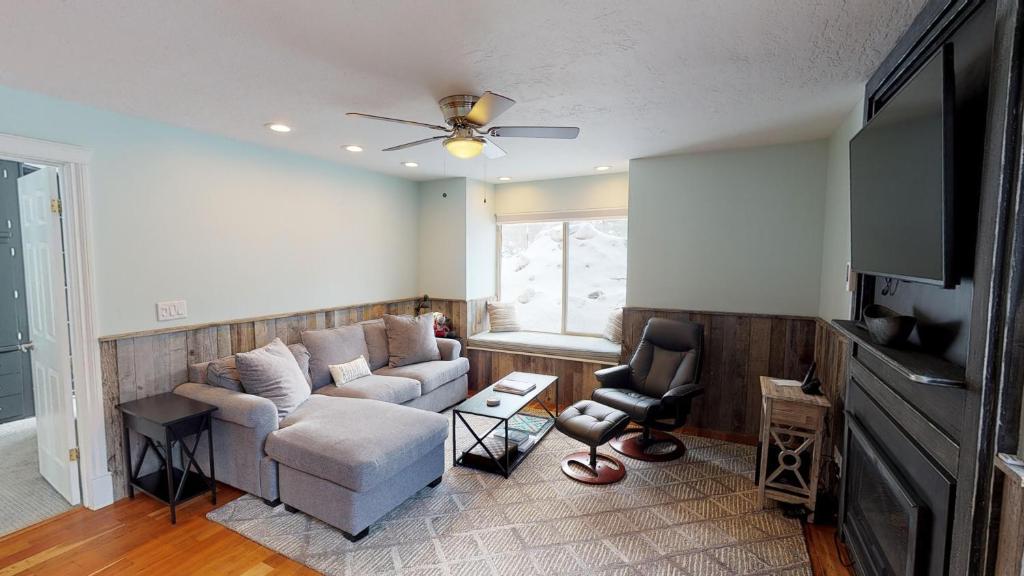 ein Wohnzimmer mit einem Sofa und einem TV in der Unterkunft Hidden Creek by All Seasons Resort Lodging in Park City