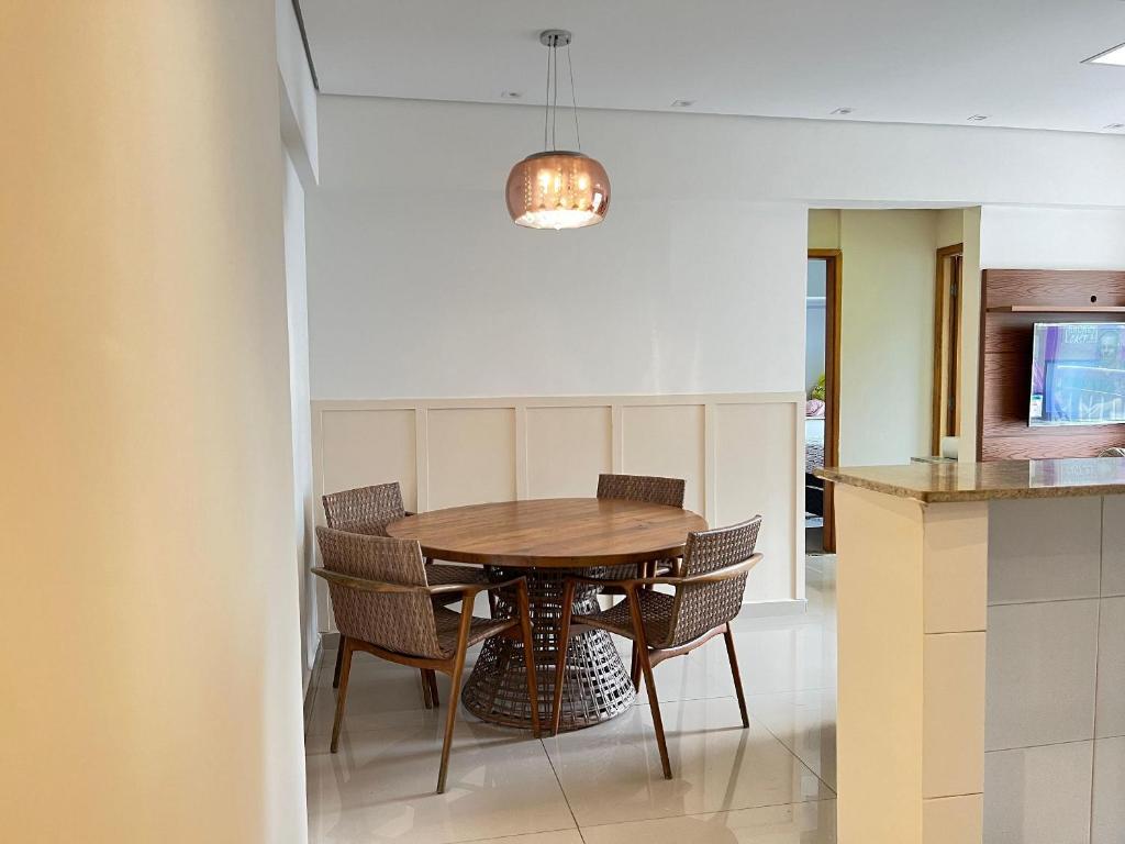 a dining room with a wooden table and chairs at 2 Min da Praia! / 2 Quartos / Vaga de Garagem in Santos