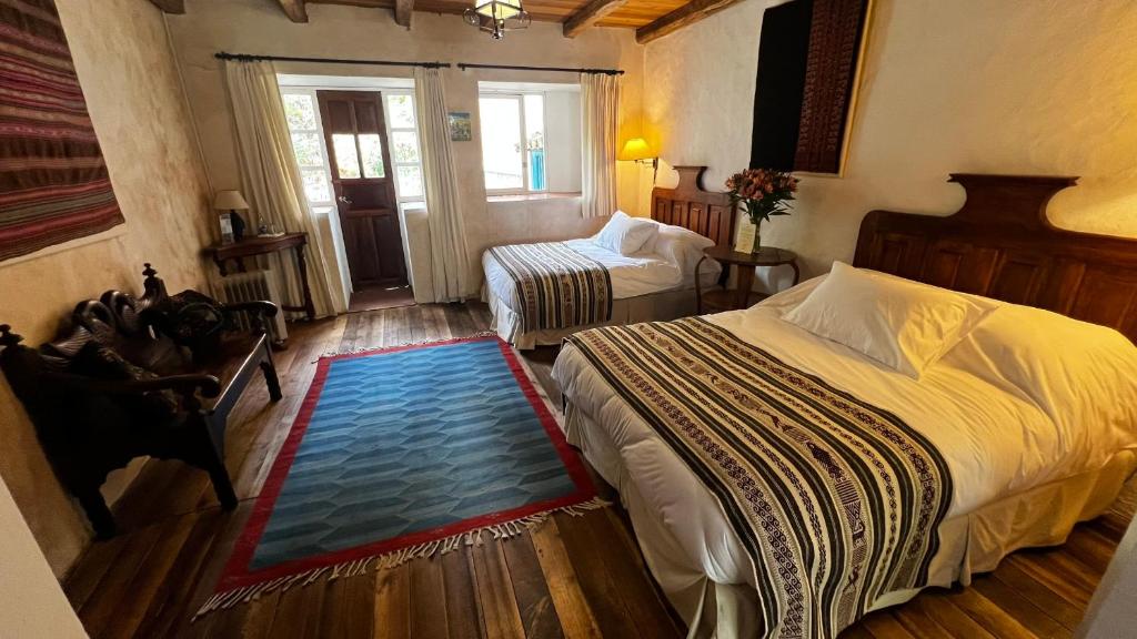 Postel nebo postele na pokoji v ubytování Hacienda Cusin