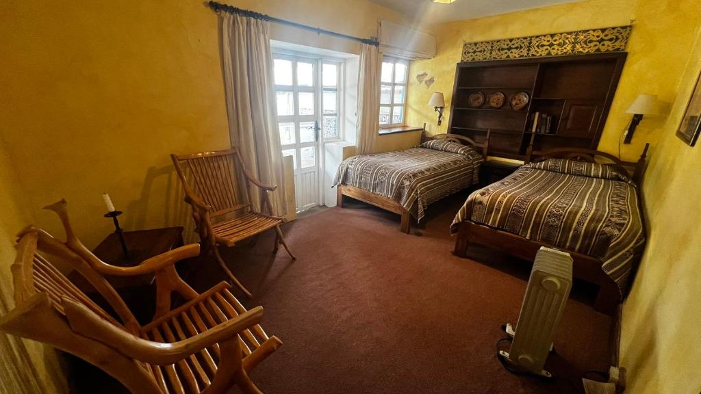Postel nebo postele na pokoji v ubytování Hacienda Cusin