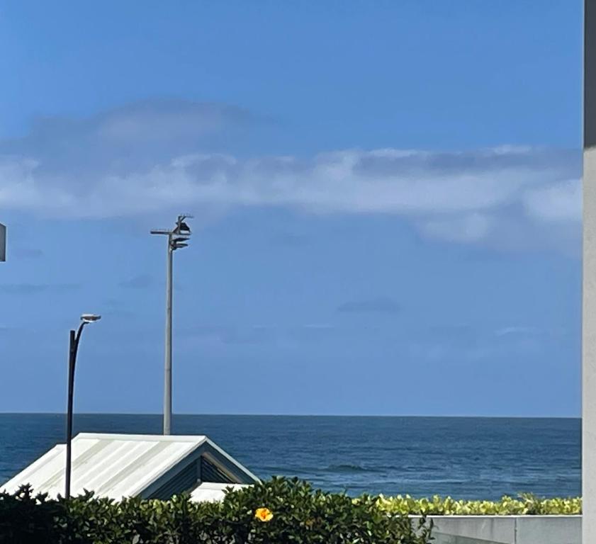 a view of the ocean with a street light and a building at Shellharbour Haven in Shellharbour
