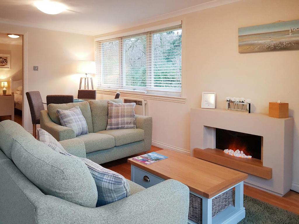 a living room with two couches and a fireplace at Leven Lodge 3 - Uk46045 in Balloch