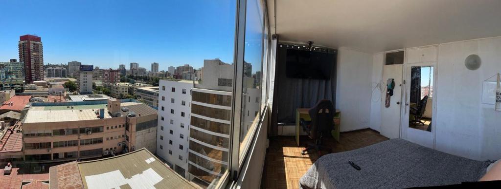 a room with a view of a city at Departamento centro de Viña in Viña del Mar