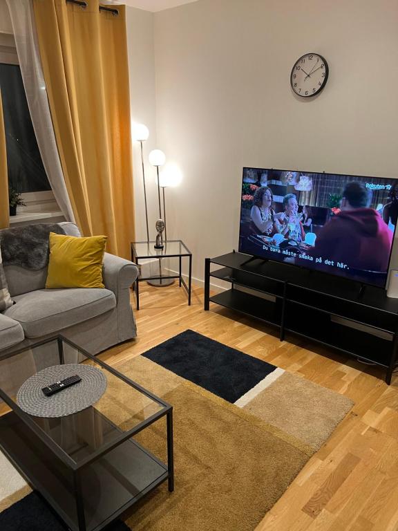 a living room with a large flat screen tv at Noah Longstay Apartment in Västerås