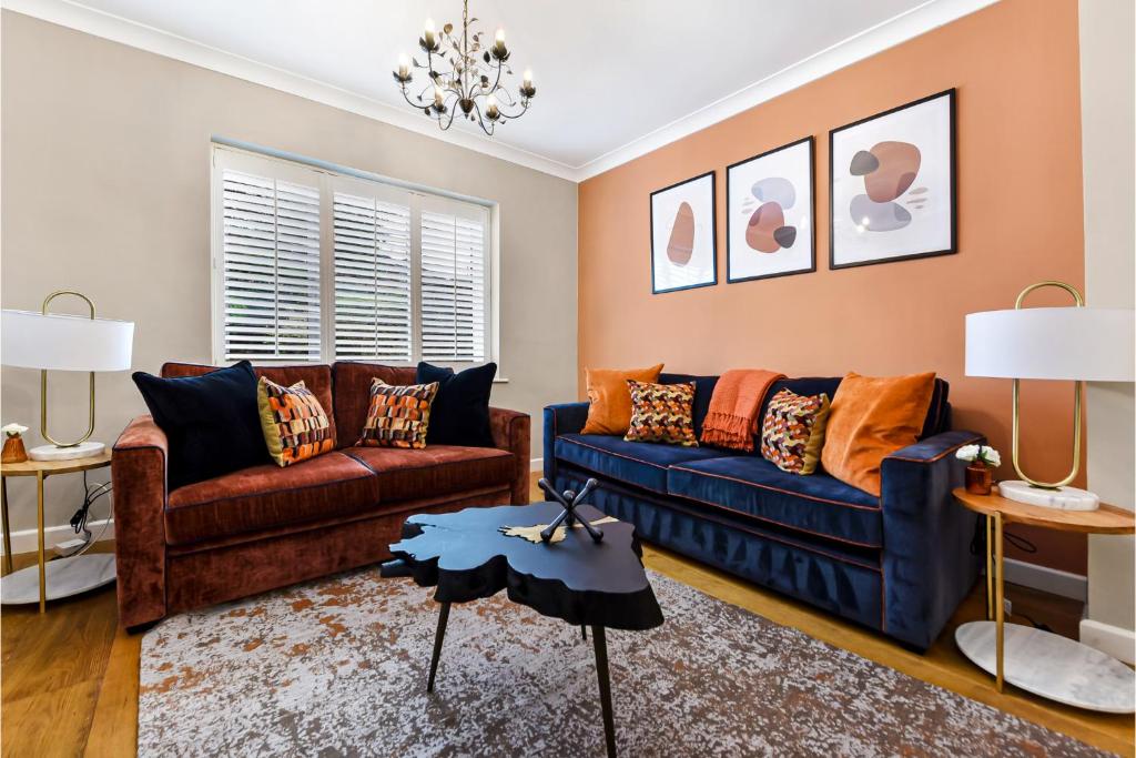 a living room with two couches and a table at The Secret Lake House in Brookwood