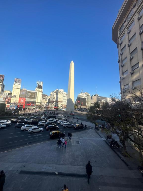 a parking lot with cars parked in a city at CorrientesNice in Buenos Aires