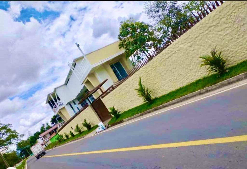 a house sitting on the side of a road at Casa el Recuerdo in Villavicencio