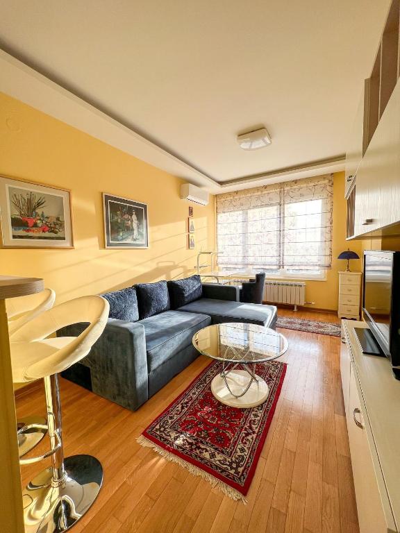 a living room with a couch and a table at Mega Lux Apartment in Vračar (historical)