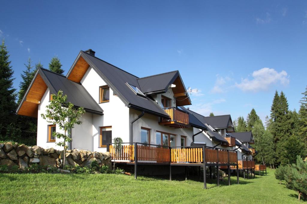 a house with a black roof at Domek Buflak in Nowy Targ