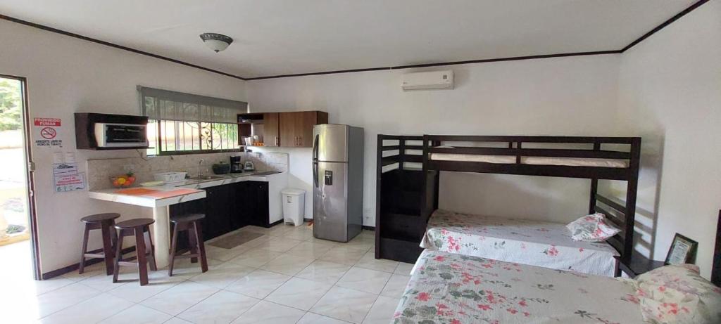 a small kitchen with a bunk bed in a room at Villas jr estudio 1 by Oasis Guacalillo in Tarcoles