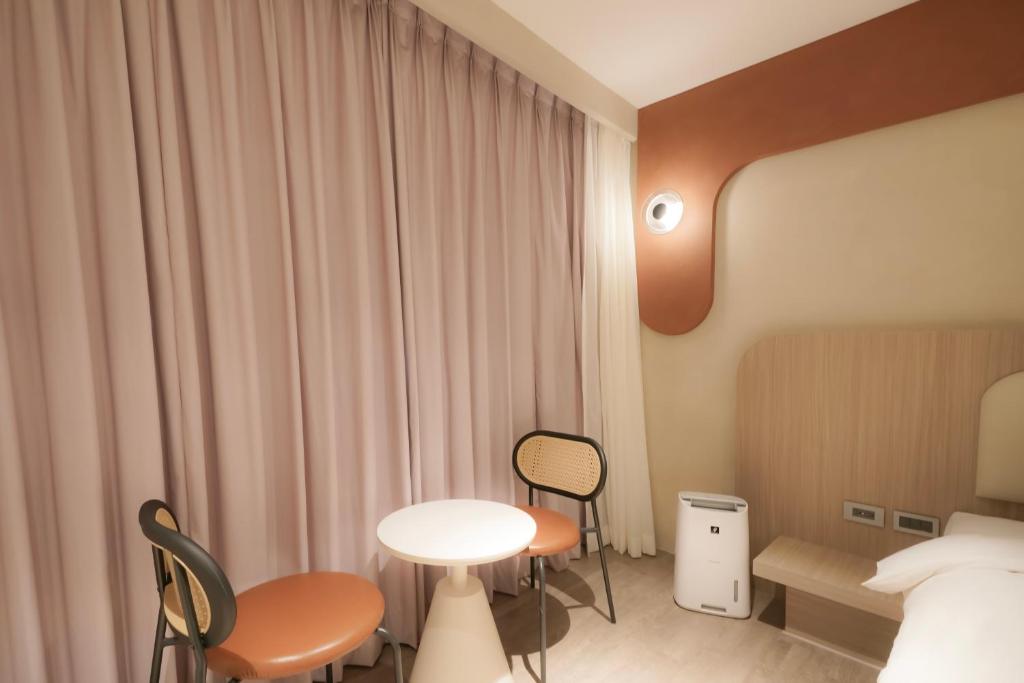 Postel nebo postele na pokoji v ubytování Hope Hotel Tainan