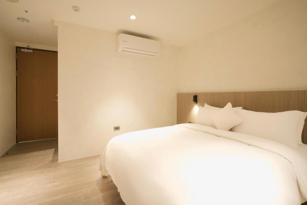 Postel nebo postele na pokoji v ubytování Hope Hotel Tainan