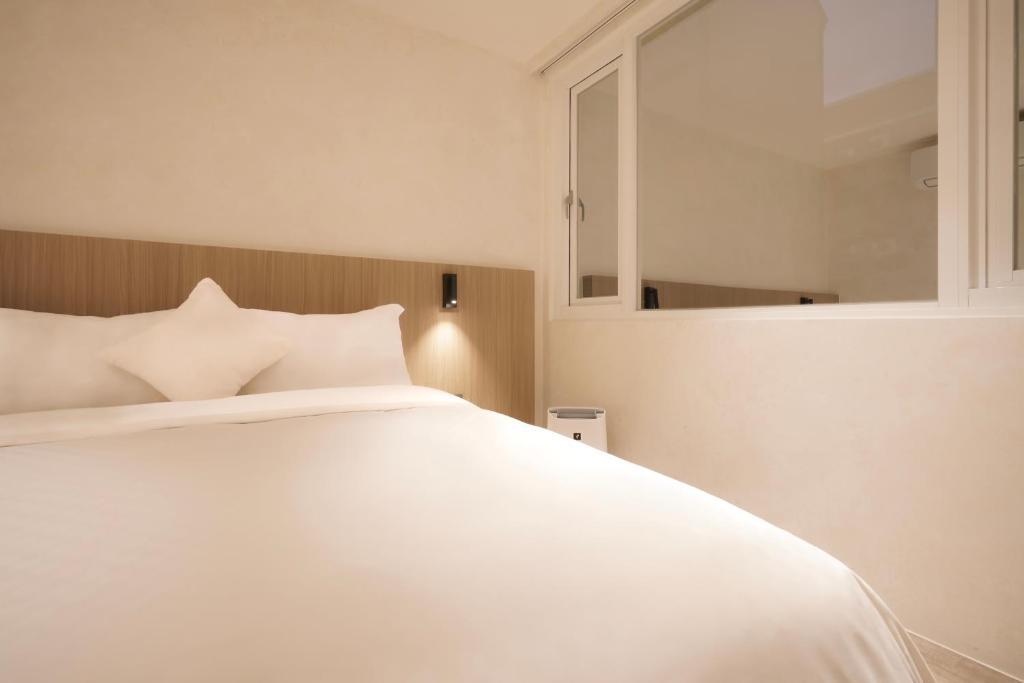 Postel nebo postele na pokoji v ubytování Hope Hotel Tainan