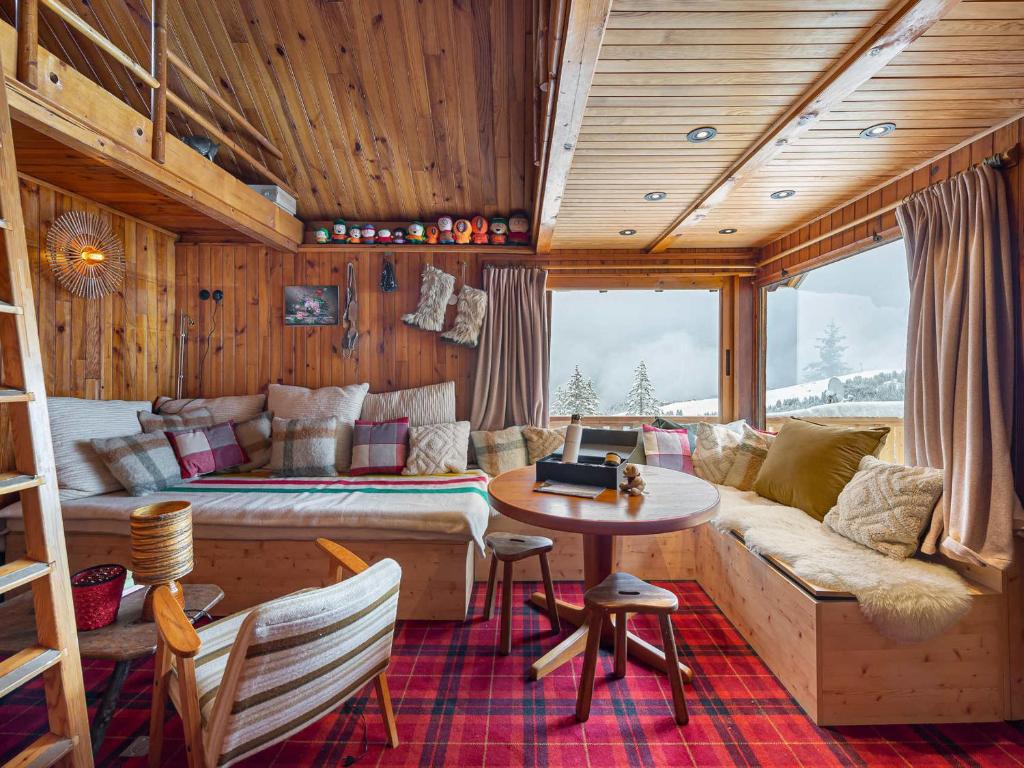 a living room with a couch and a table at Chalet Courchevel 1850, 4 pièces, 4 personnes - FR-1-564-97 in Courchevel