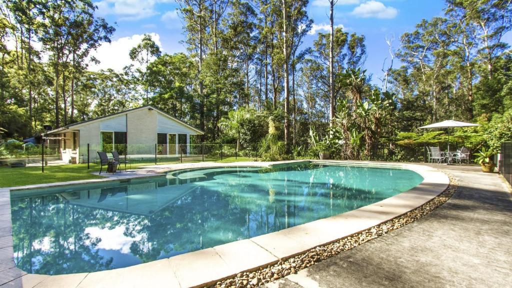 a swimming pool in a yard with a house at Wirreanda Retreat Acreage in Macmasters Beach