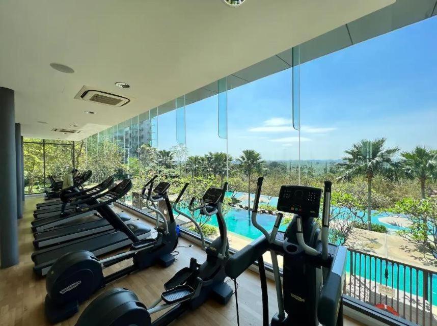a gym with cardio machines and a view of a pool at Classical Cozy Iskandar Residence 3BR nr Legoland by Our Stay in Nusajaya