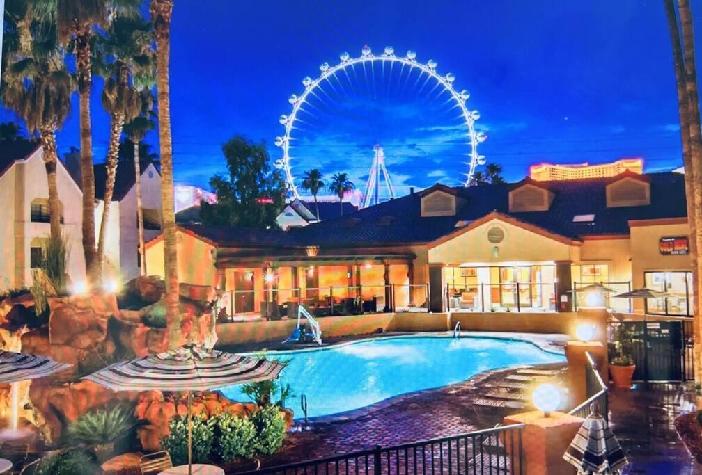 a resort with a swimming pool and a ferris wheel at Weekends in May and June - Amazing Deluxe 1-Bedroom - Next to Sphere in Las Vegas! in Las Vegas