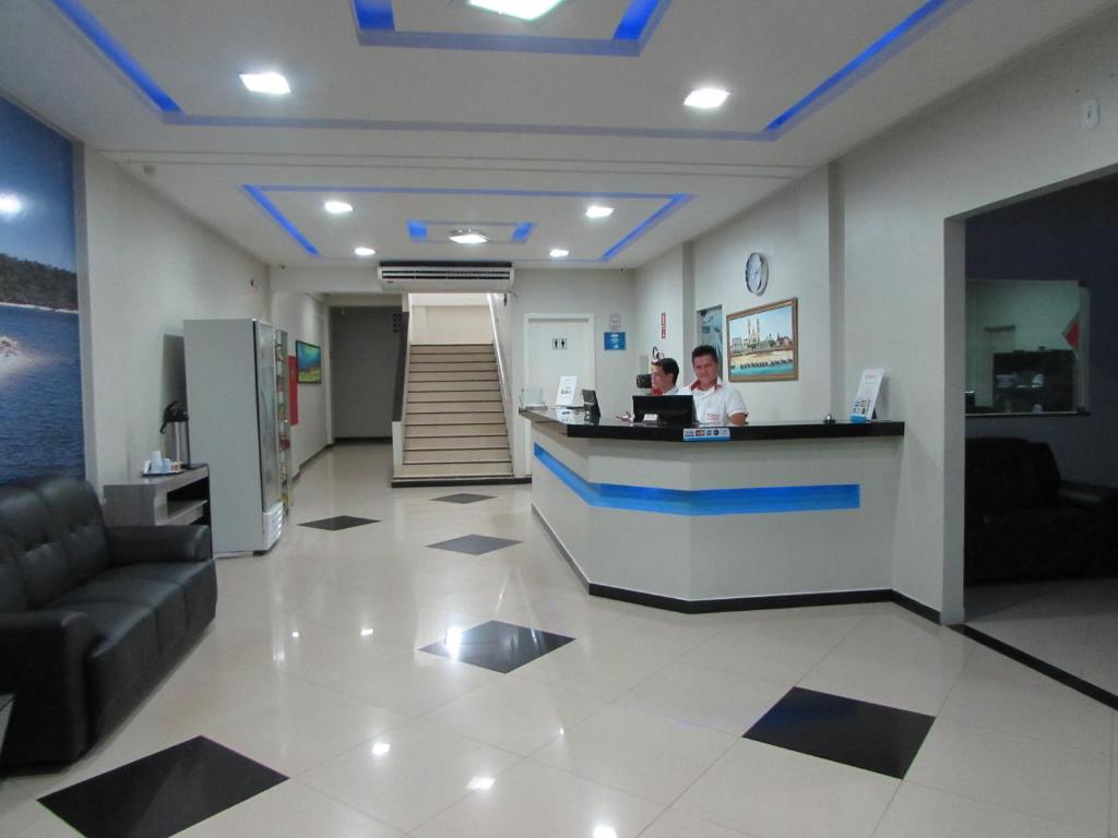 a lobby of a pharmacy with a pharmacist at a counter at Tapajós Center Hotel in Santarém