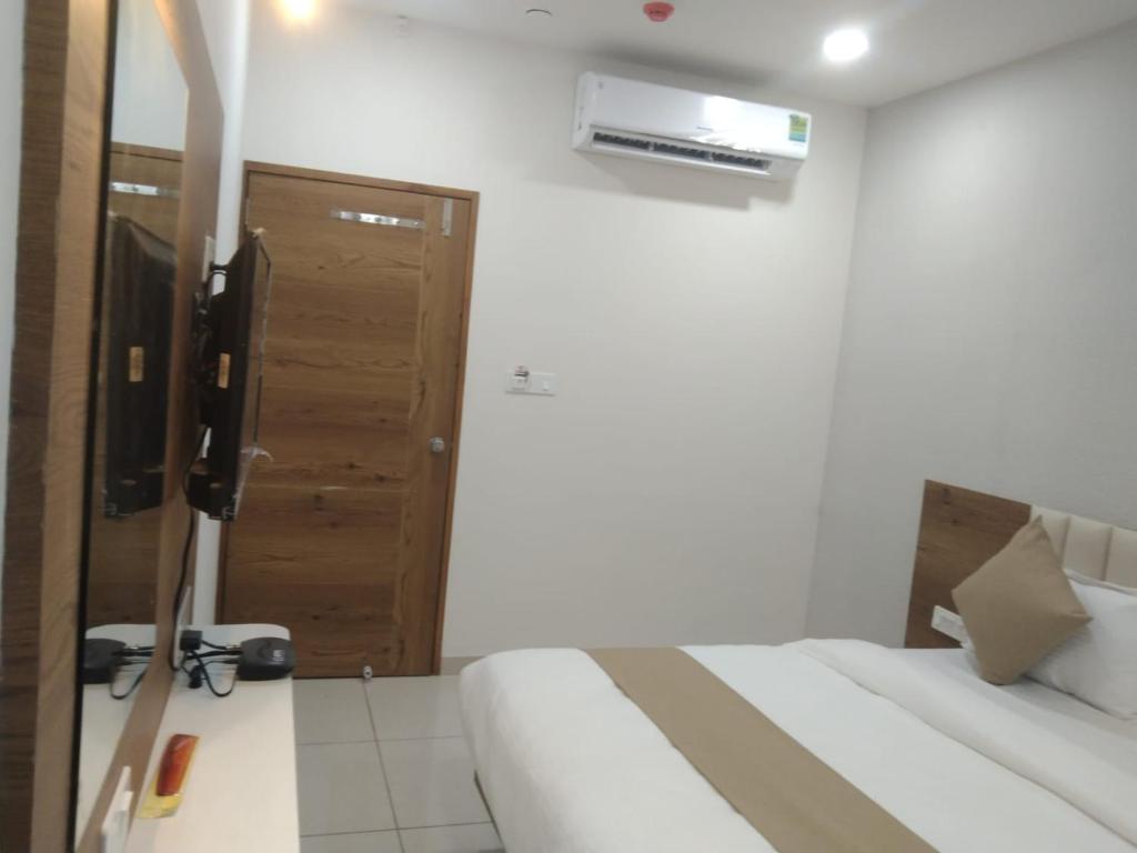 Postel nebo postele na pokoji v ubytování Hotel Md Residency