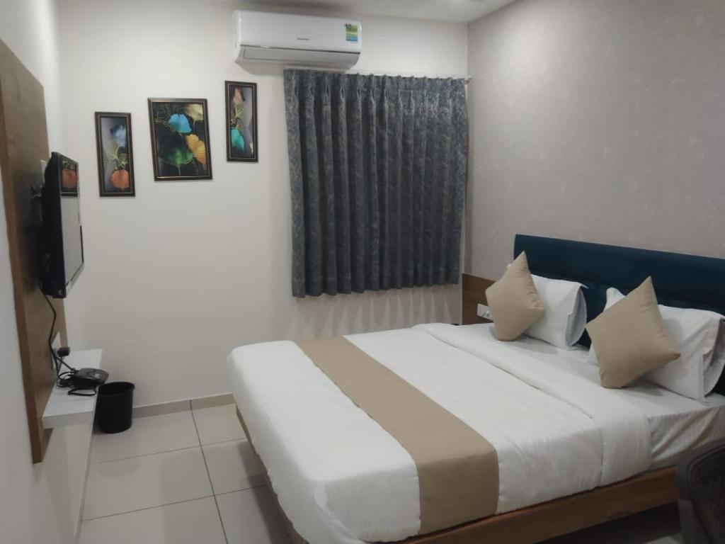 Postel nebo postele na pokoji v ubytování Hotel Md Residency