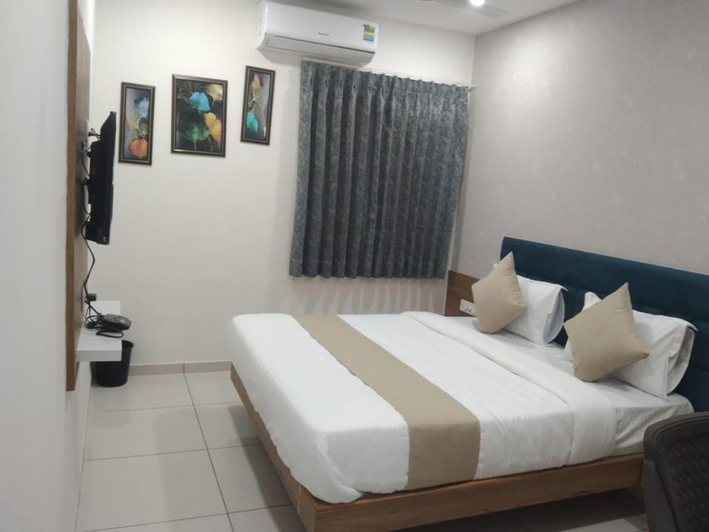 Postel nebo postele na pokoji v ubytování Hotel Md Residency