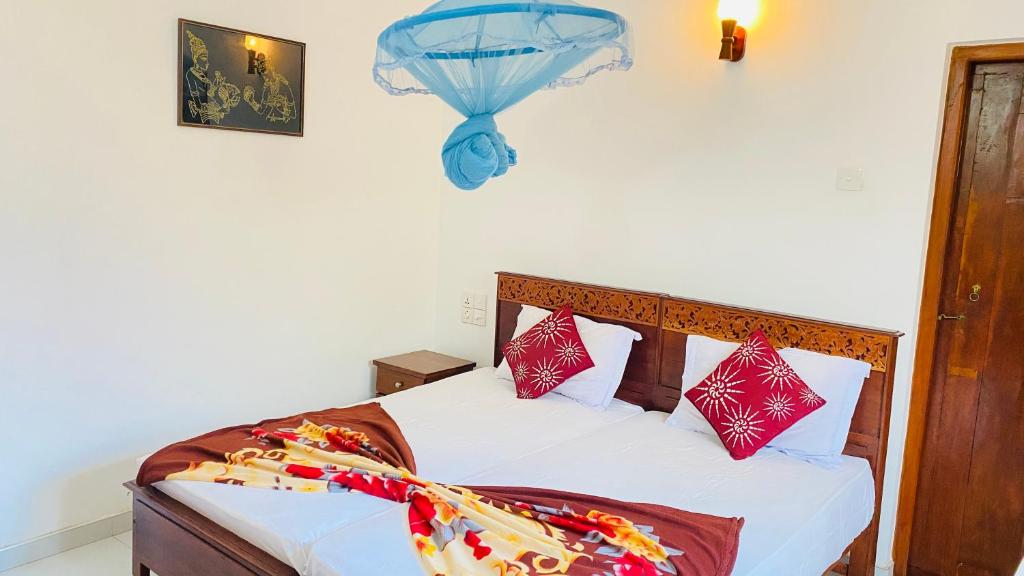 a bedroom with a bed with a blue umbrella at Sanasuma Villa in Bentota