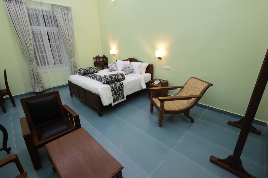 Postel nebo postele na pokoji v ubytování Le Colonial Suites
