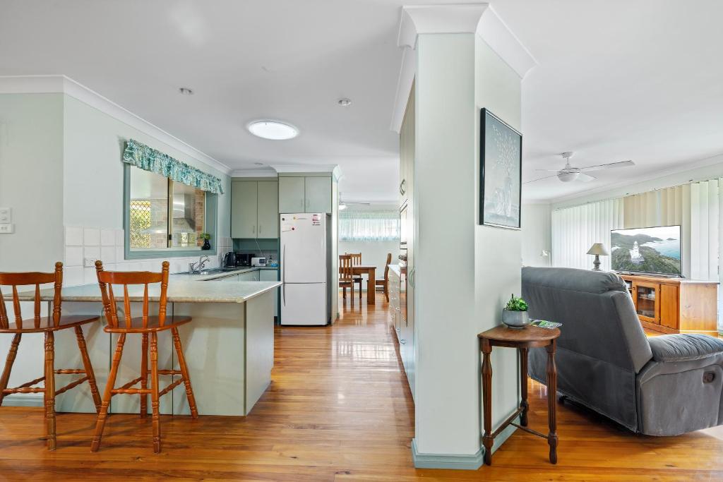 a kitchen and a living room with a table and chairs at Beach Dreams Hat Head - No Sheets or Towels provided in Hat Head