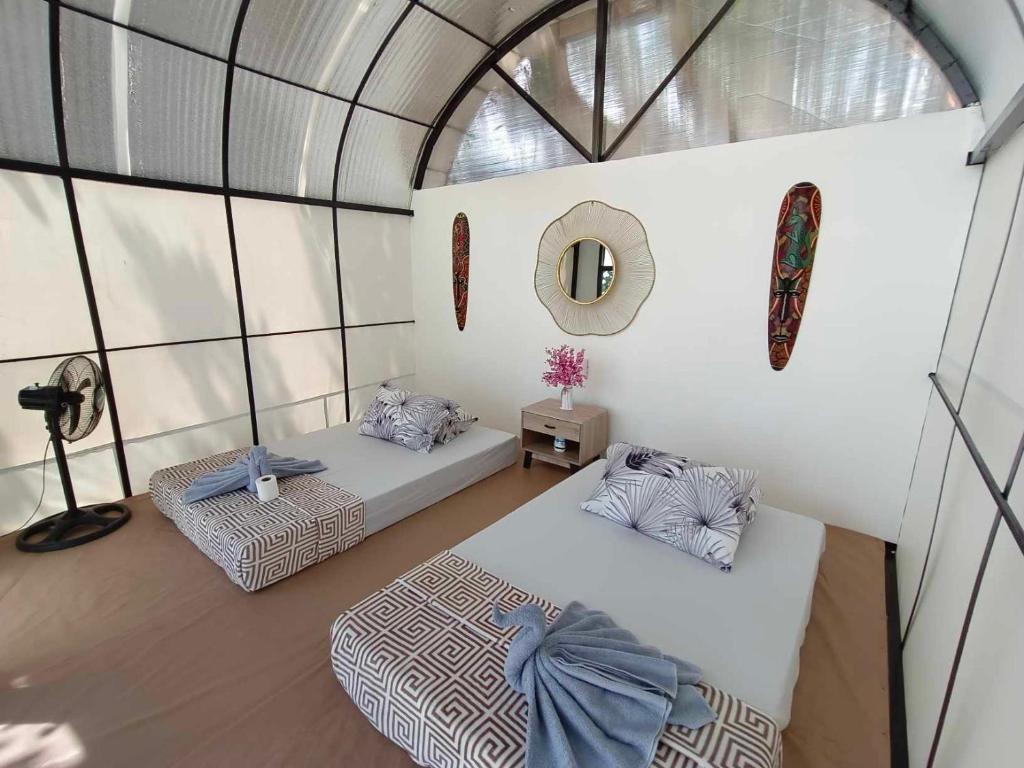 an overhead view of a room with two beds and a mirror at Siquijor Glamping Village in San Juan