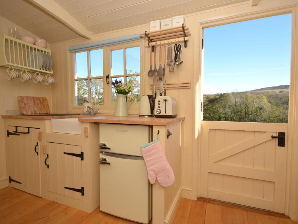 a kitchen with a barn door and a counter at 1 bed in Llandyfan 65190 in Llandybie