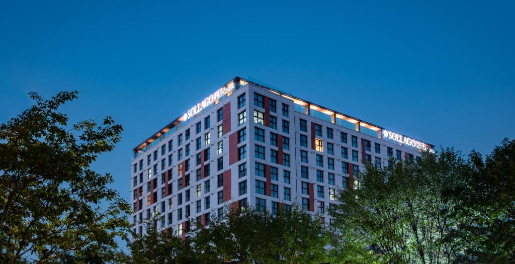 a tall building with lights on the top of it at Sollago Myeongdong Hotel & Residence in Seoul