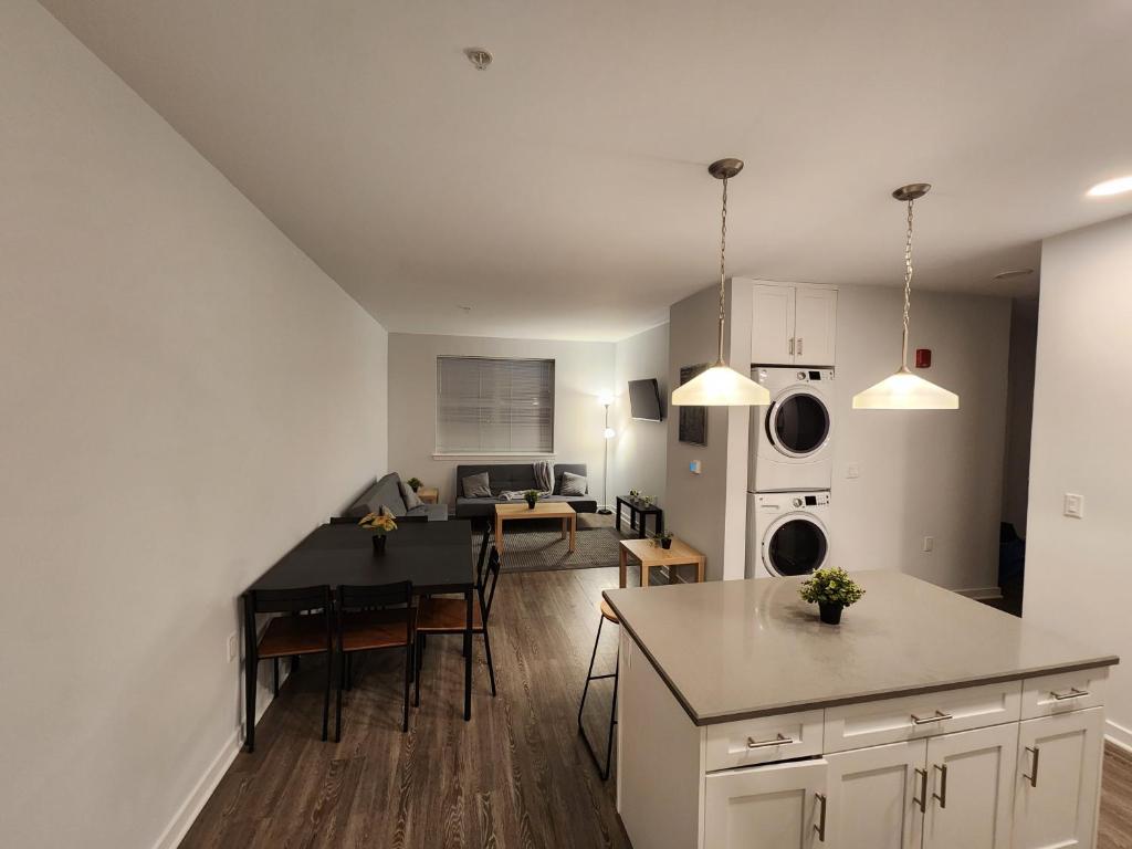 a kitchen and living room with a table and a dining room at Modern 2 bed apt, mins to NYC! in Jersey City