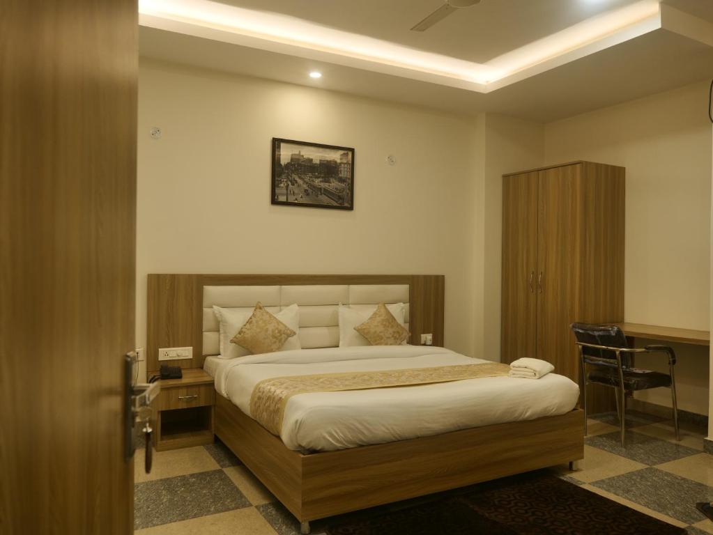 a bedroom with a bed and a table and a desk at Silver Bliss in Lucknow