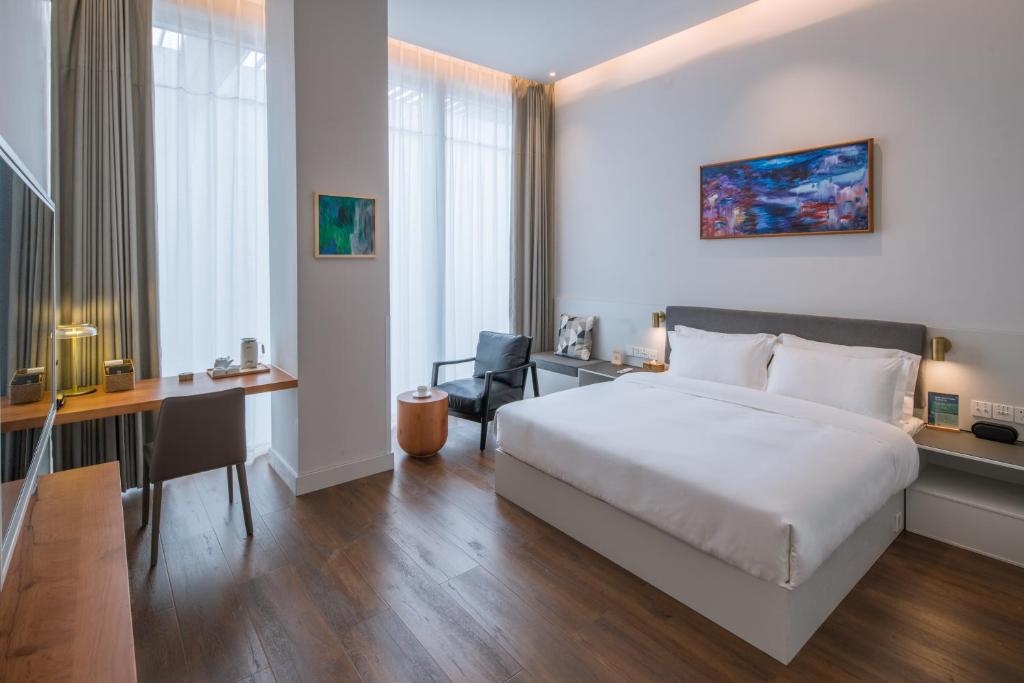 Letto o letti in una camera di Wuyu Hotel Chongqing Zoo & Yangjiaping The Mixc Light rail