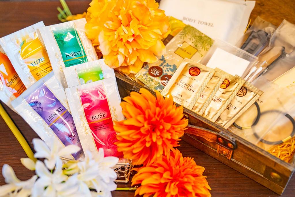 a table with flowers and a box of products at Hotel Actel Nagoya Nishiki in Nagoya