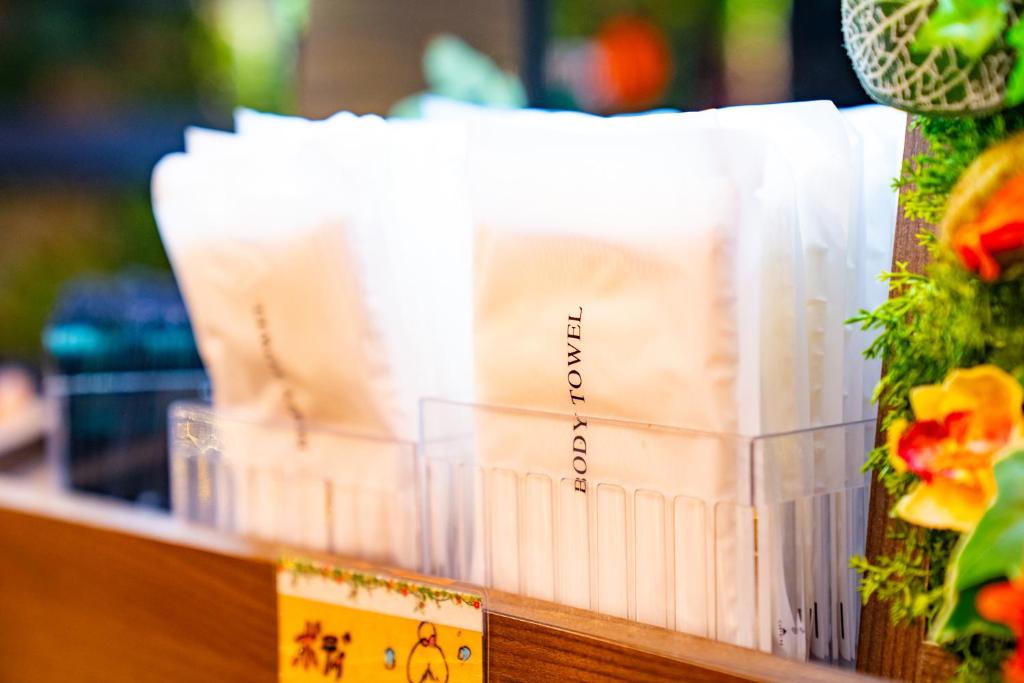 a group of white books sitting on a shelf at Hotel Actel Nagoya Nishiki in Nagoya